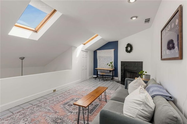 living room featuring a skylight, vaulted ceiling, tile patterned floors, a fireplace, and recessed lighting