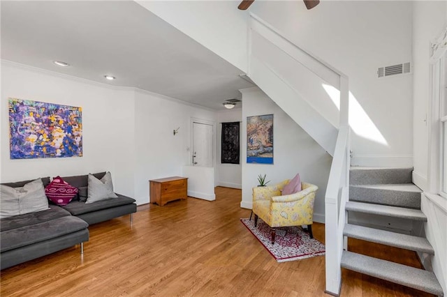 living area with light wood-type flooring, stairs, baseboards, recessed lighting, and ceiling fan