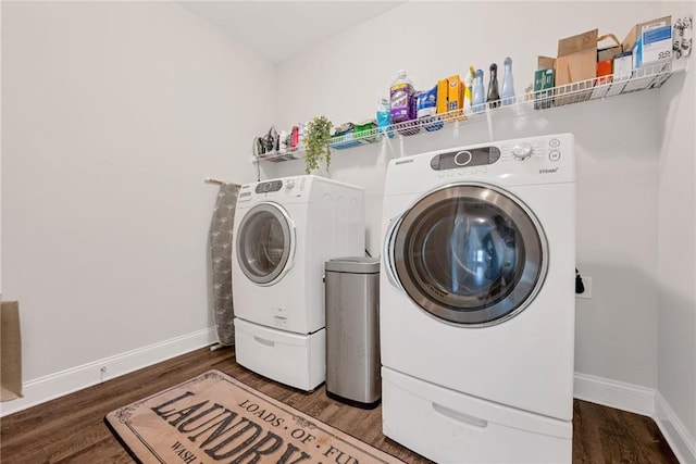 laundry area featuring dark wood-type flooring and washing machine and clothes dryer