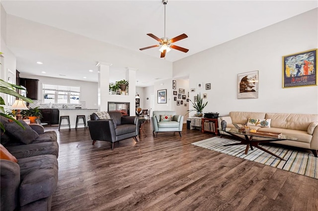 living room with dark hardwood / wood-style floors and ceiling fan