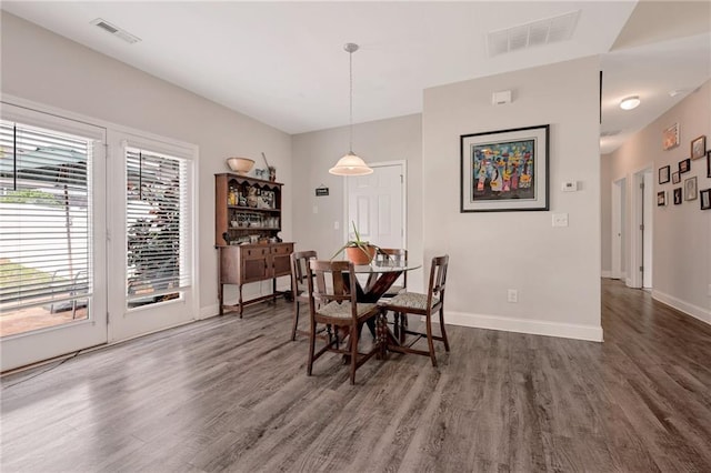 dining space featuring dark wood-type flooring