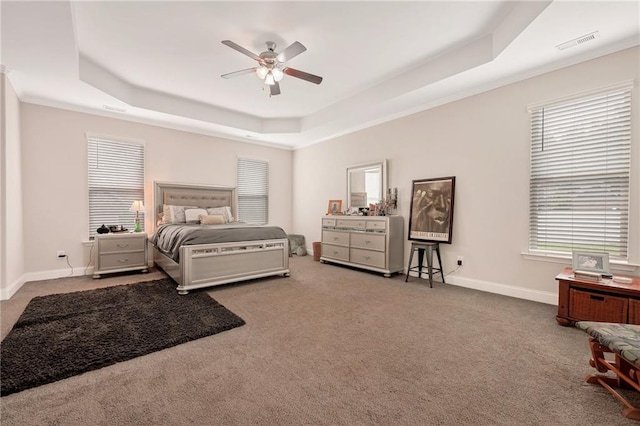 bedroom featuring ceiling fan, a raised ceiling, and carpet flooring