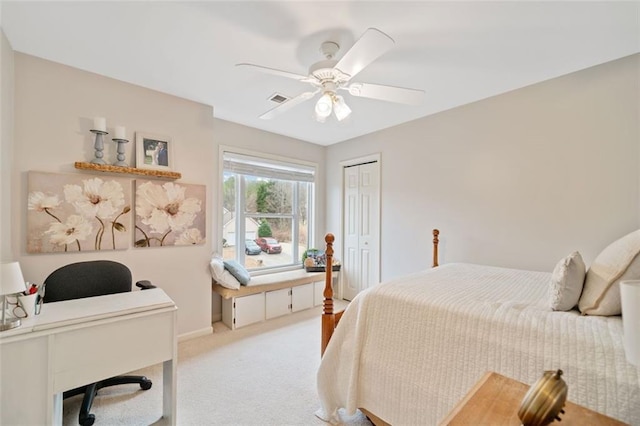 carpeted bedroom featuring ceiling fan and a closet