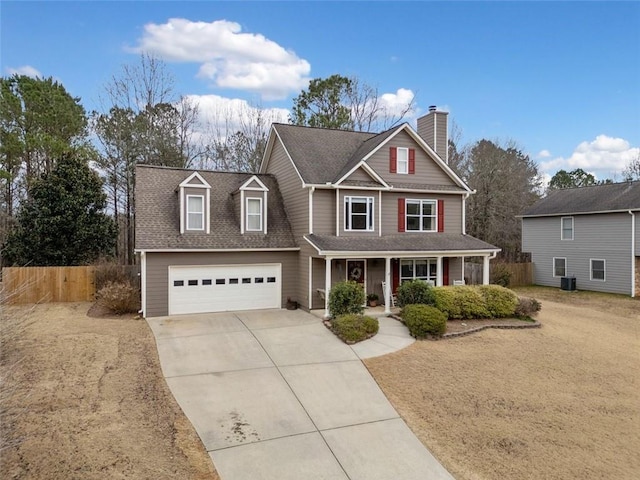 view of front facade with a garage, central AC, and covered porch