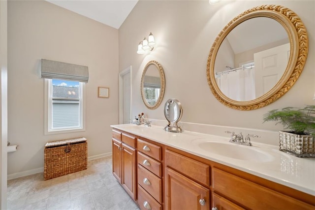 bathroom with lofted ceiling and vanity