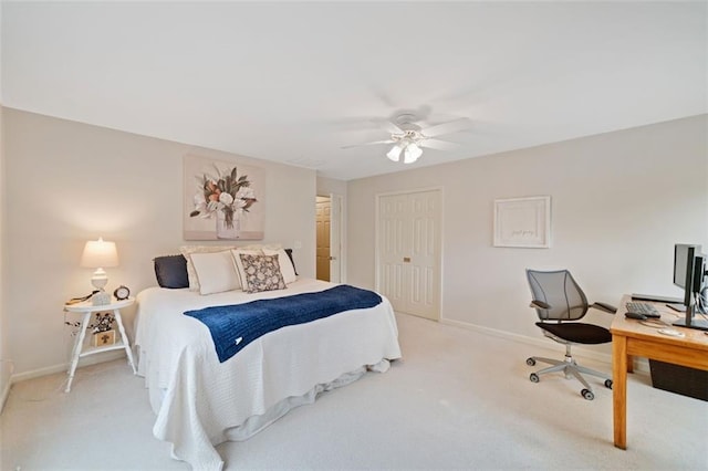 carpeted bedroom with ceiling fan and a closet