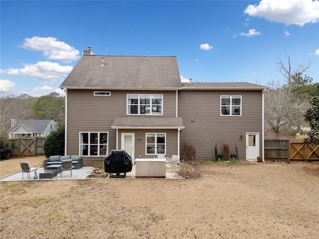 back of property with an outdoor living space, a yard, and a patio area