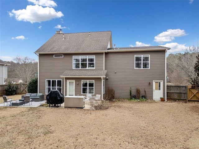 back of house with an outdoor living space and a patio