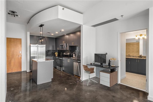 kitchen with appliances with stainless steel finishes, backsplash, and concrete floors