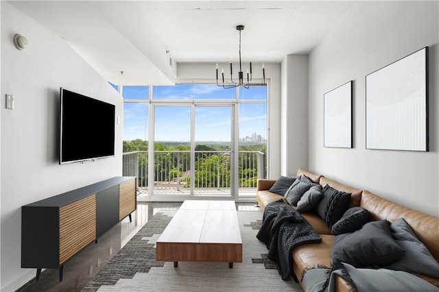 living room featuring a wall of windows and a chandelier