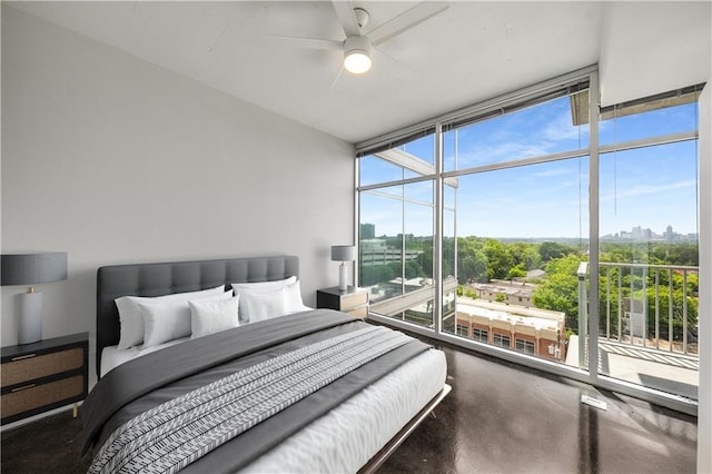 bedroom featuring a wall of windows, a view of city, and ceiling fan