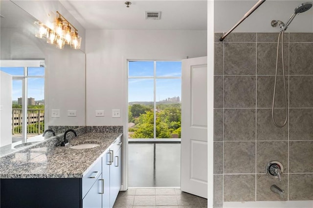 bathroom featuring vanity, tile patterned floors, shower / tub combination, and a chandelier