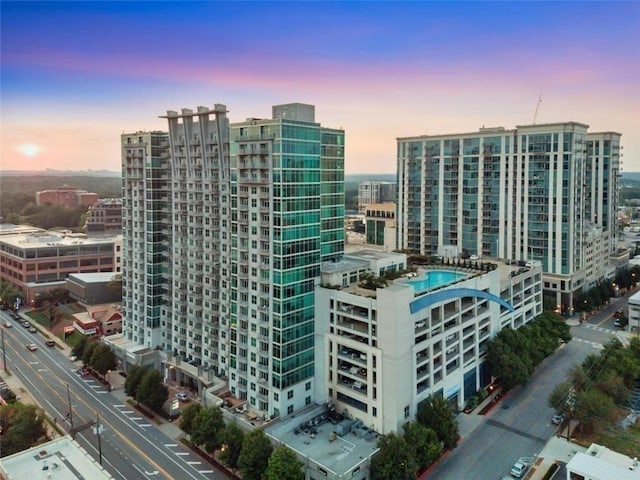 property at dusk with a city view