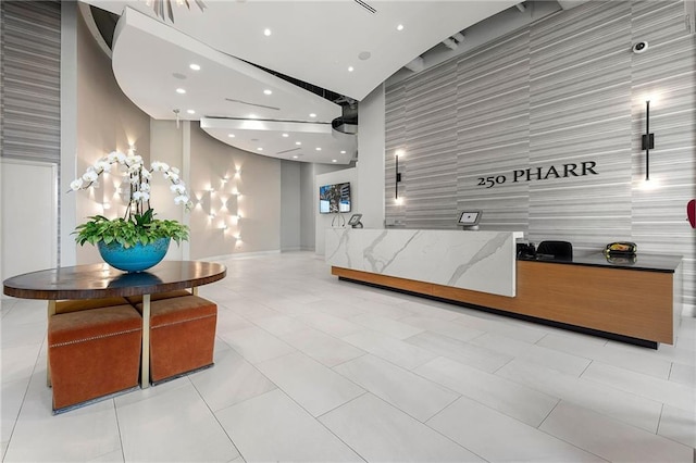 reception featuring recessed lighting and a towering ceiling