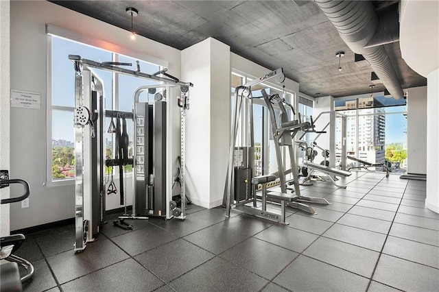 gym featuring plenty of natural light and baseboards