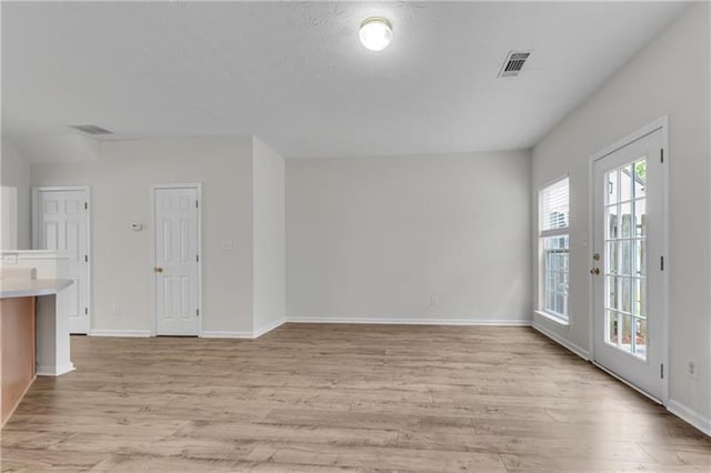 621 Kenridge Way Unit 0, Suwanee, GA 30024 - unfurnished living room featuring light wood-type flooring and baseboards