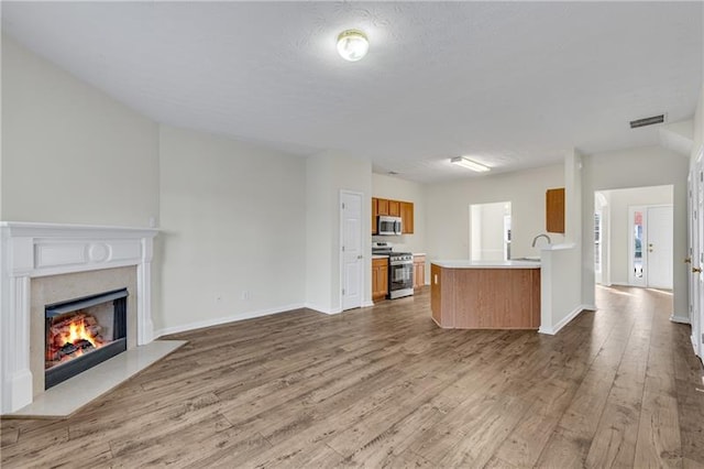 621 Kenridge Way Unit 0, Suwanee, GA 30024 - unfurnished living room with wood finished floors, a high end fireplace, and baseboards