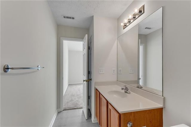 621 Kenridge Way Unit 0, Suwanee, GA 30024 - bathroom featuring vanity, a textured ceiling, and baseboards