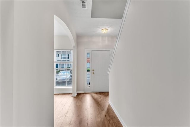 621 Kenridge Way Unit 0, Suwanee, GA 30024 - entrance foyer featuring arched walkways, wood finished floors, and baseboards