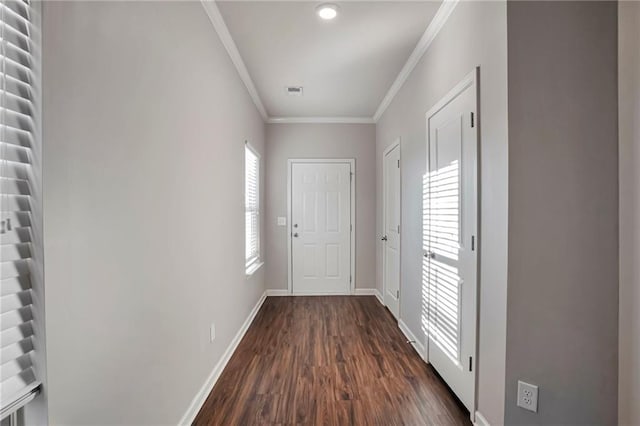 entryway featuring ornamental molding and dark hardwood / wood-style floors