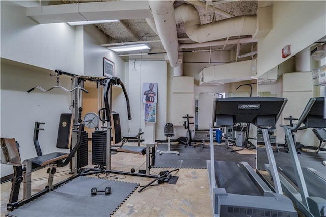 workout area featuring a towering ceiling