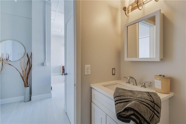 bathroom with vanity and baseboards