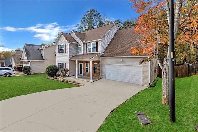 view of front property with a garage, covered porch, and a front lawn