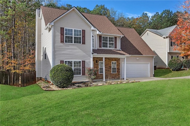 view of front of property with a garage and a front lawn