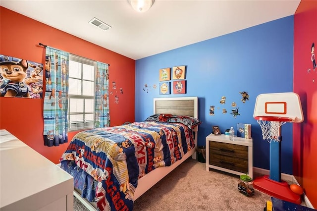 carpeted bedroom featuring baseboards and visible vents