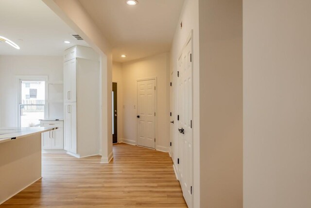 hallway with light hardwood / wood-style flooring