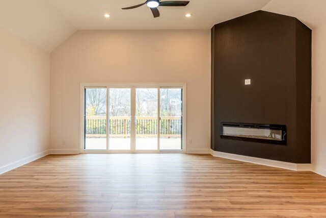 unfurnished living room featuring vaulted ceiling, ceiling fan, and light wood-type flooring