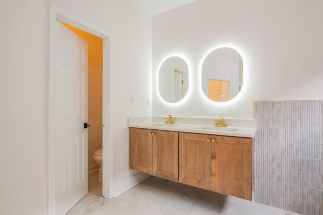 bathroom with vanity, tile patterned floors, and toilet