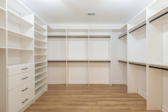 spacious closet with light hardwood / wood-style flooring