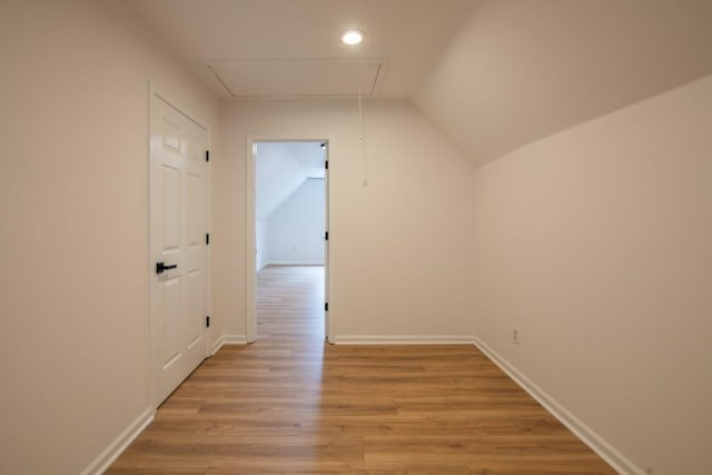 interior space featuring lofted ceiling and light hardwood / wood-style floors