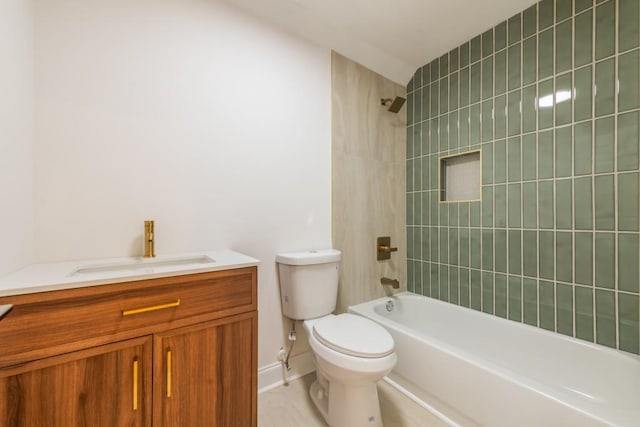 full bathroom featuring tiled shower / bath, vanity, and toilet