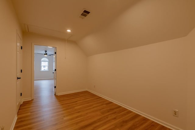 additional living space featuring lofted ceiling and light hardwood / wood-style flooring