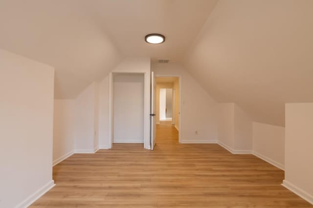 bonus room featuring lofted ceiling and light hardwood / wood-style floors