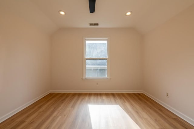 additional living space with lofted ceiling, light hardwood / wood-style flooring, and ceiling fan