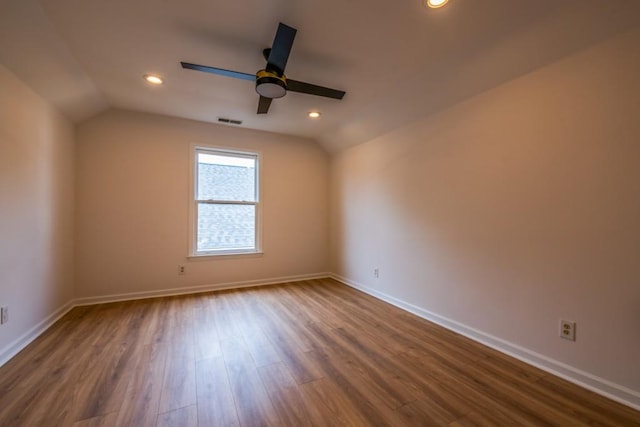 empty room with wood-type flooring, ceiling fan, and vaulted ceiling