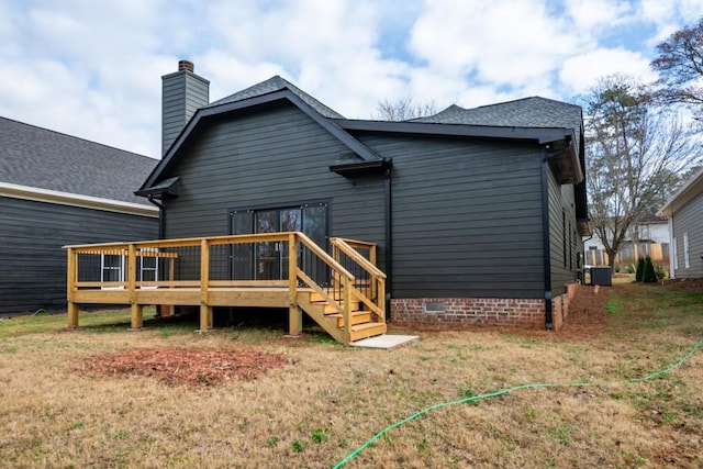 rear view of house featuring central AC unit, a yard, and a deck