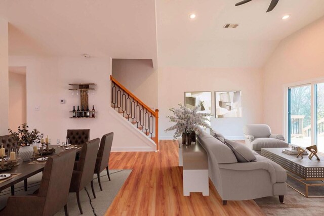 living room featuring vaulted ceiling, ceiling fan, and light hardwood / wood-style floors