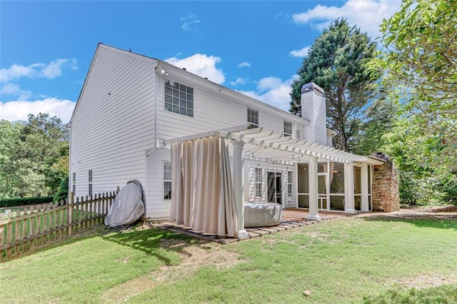 back of property with a pergola, a chimney, and a patio area