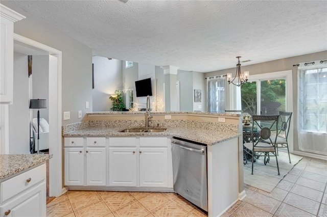 kitchen with dishwasher, a sink, a peninsula, white cabinetry, and a chandelier