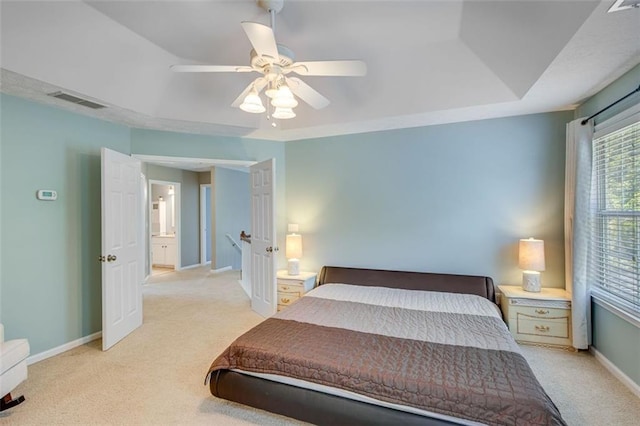 bedroom featuring light colored carpet, baseboards, and ceiling fan