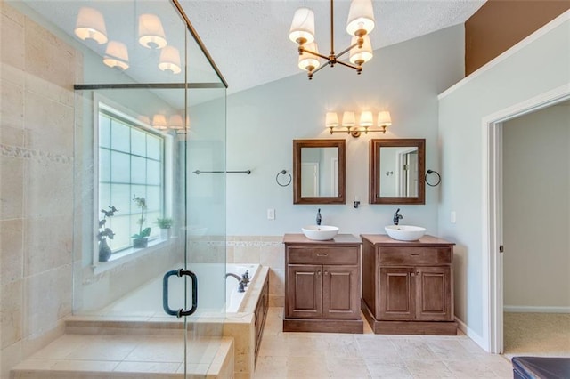 full bath featuring a chandelier, vaulted ceiling, a garden tub, a stall shower, and double vanity