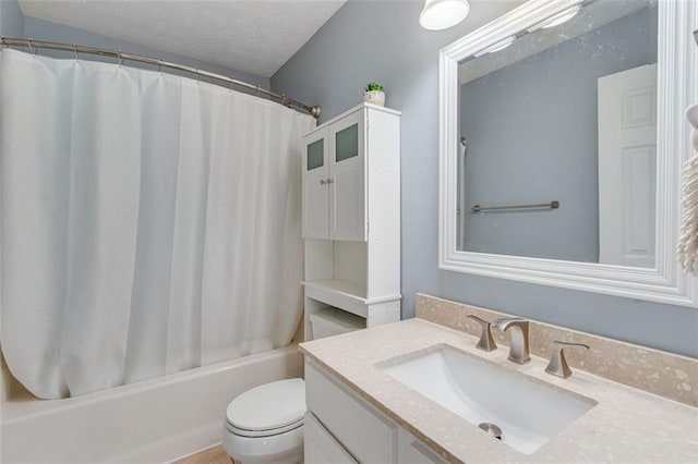 full bathroom featuring vanity, shower / tub combo, toilet, and a textured ceiling