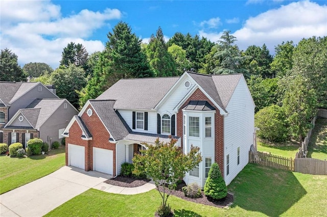 traditional home with concrete driveway, an attached garage, brick siding, and a shingled roof