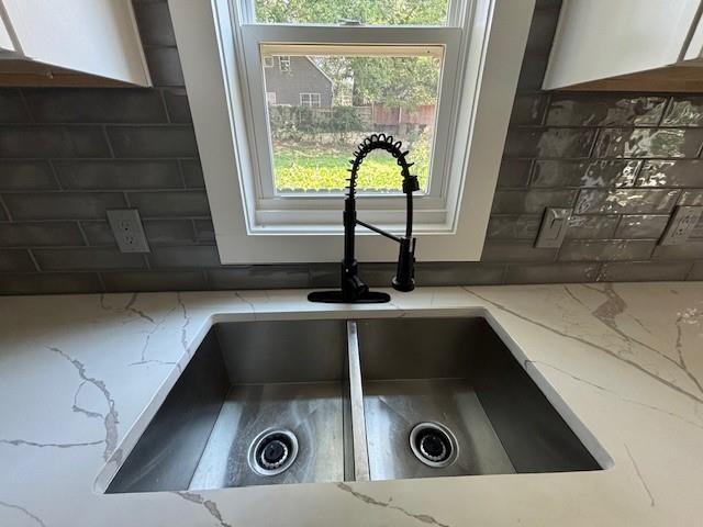 room details featuring sink and backsplash