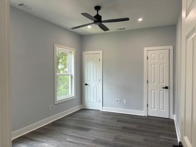 unfurnished bedroom with dark hardwood / wood-style floors and ceiling fan