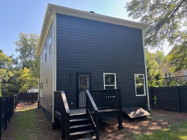 back of property featuring a wooden deck